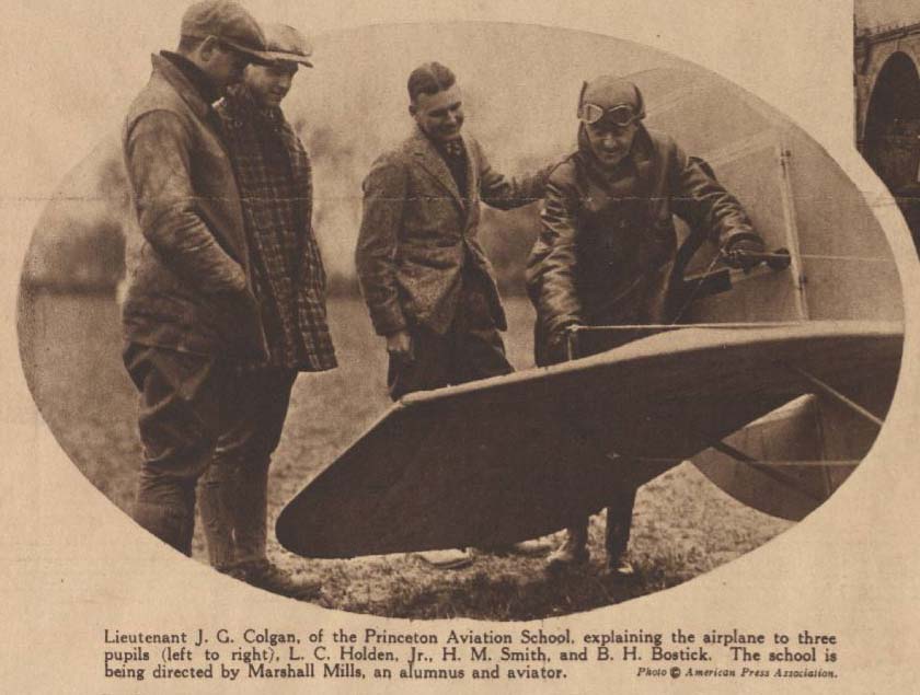 A Newspaper clipping showing a photo of four men peering at the wing of a plane. The caption identifies them as Lt. Colgan of the Princeton Aviation School, and three pupils: L. C. Holden, Jr., H. M. Smith, and B. H. Bostick.