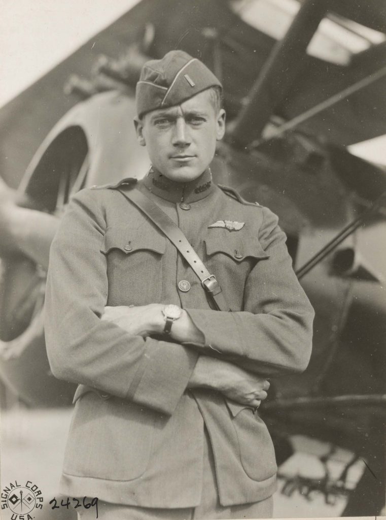 Close-up three quarter photo of Callahan in uniform in front of an airplane.