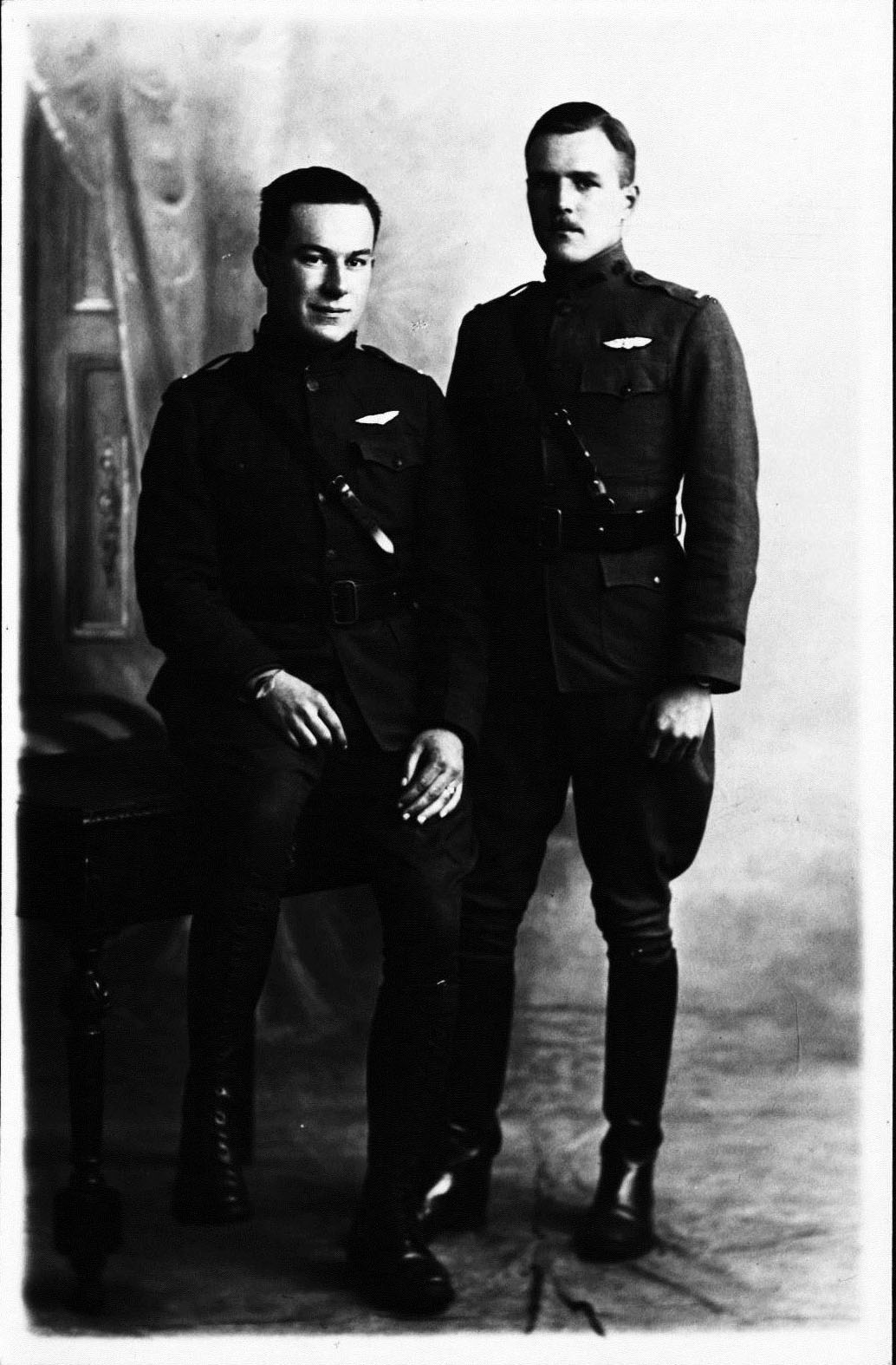 A formally photo of two men in uniform with pilot's wings. Shaw is recognizable on the left, Deetjen on the right.