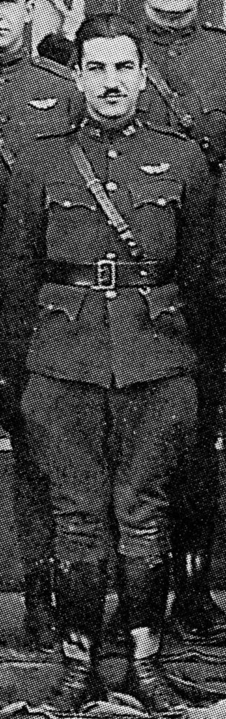 Detail from a rather grainy photo showing a hatless man, Desson, in uniform with pilot's wings over his left breast pocket.