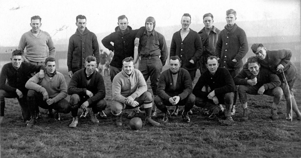 An informal shot of fifteen men ready to play football.