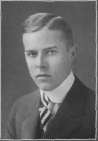 Head and shoulders photo of a serious looking young man in suit and tie.