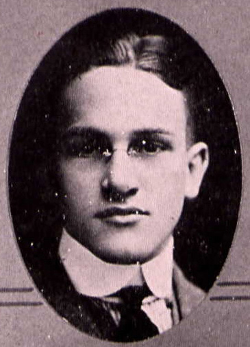 Yearbook photo of Hamilton showing his face and a high collar and tie. He is apparently wearing rimless glasses.